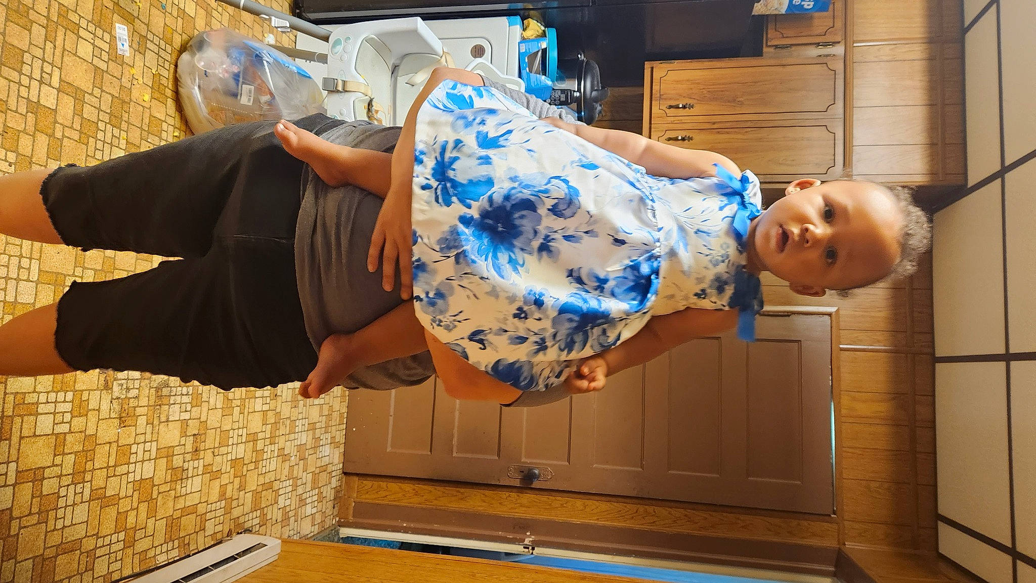 Charlotte joined the competition — help win amazing prizes! cabinetry, drawer, electric_blue, flooring, fun, happy, human_leg, pattern, person, refrigerator, room, t_shirt, thigh, toddler, wood