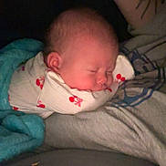 Valley is registered to the contest to win money with this photo: baby, sleeping, blanket, cherry_pattern, tattoo, arm, closeup, cozy, infant, resting, soft, person, indoors, warm_lighting, peaceful, portrait, child, wrapped, human, cute