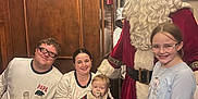 Hunter joined the competition — help win amazing prizes! family, indoor, santa_claus, child, baby, woman, man, glasses, pajamas, table, food, book, holiday, christmas_decorations, smile, beard, pacifier, wooden_paneling, festive, celebration
