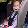 Elianna joined the competition — help win amazing prizes! baby, blue_eyes, butterfly_leggings, car_interior, car_seat, child, clothing, curly_hair, cute, daylight, happy, person, portrait, purple_top, safety_harness, seat, seatbelt, smiling, toddler, young_child