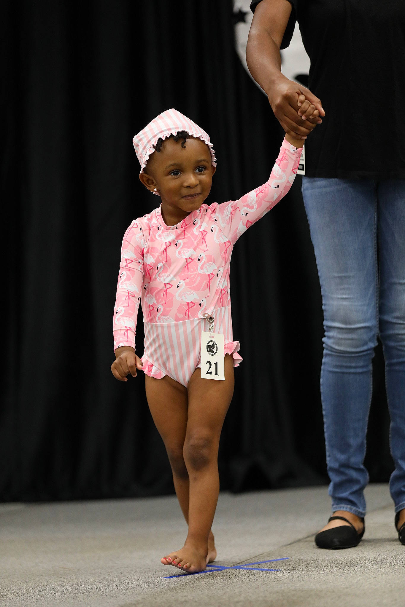 Novah joined the competition — help win amazing prizes! baby_toddler_clothing, barefoot, calf, entertainment, event, foot, fun, gesture, hand, happy, hat, holding_hands, human_leg, knee, performing_arts, person, recreation, sleeve, t_shirt, thigh