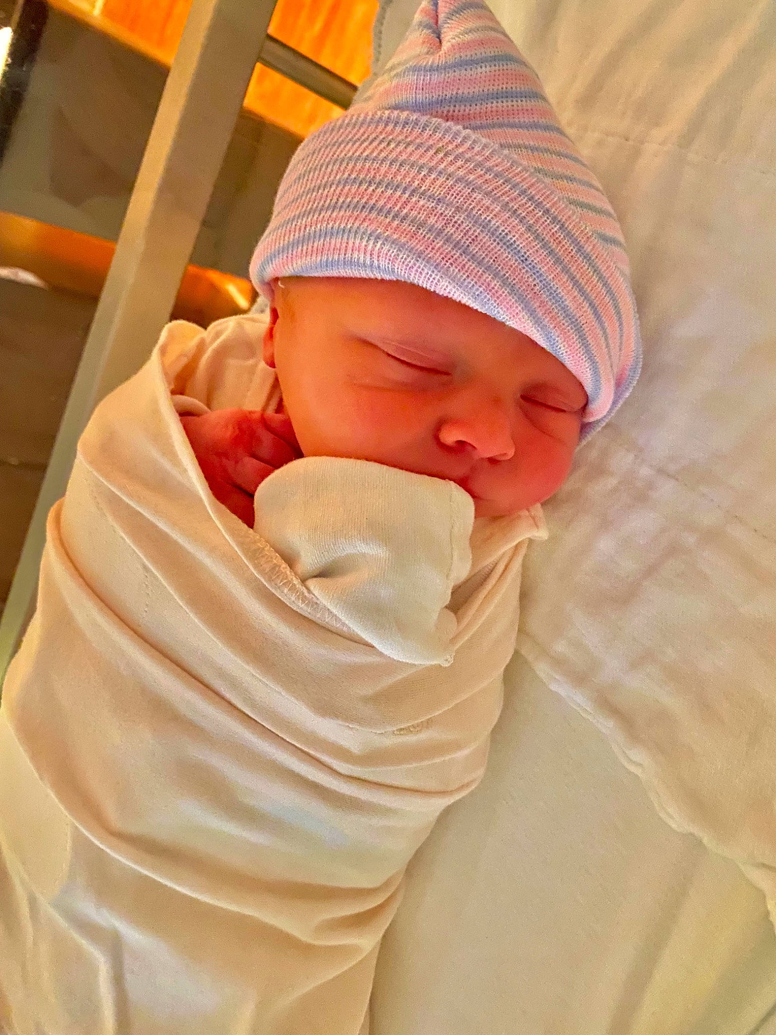 Graysen is registered to the contest to win money with this photo: baby, baby_products, baby_sleeping, baby_toddler_clothing, beanie, cap, cheek, child, comfort, hat, headwear, human_body, knit_cap, linens, orange, peach, person, pink, skin, sleeve