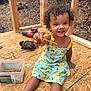 toddler, child, smiling, dress, yellow, curly_hair, screws, tools, construction, wood_floor, box, glove, drill, outdoor, happy, person, playful, building, sitting, daylight
