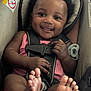 baby, car_seat, smiling, infant, child, seatbelt, feet, happy, indoors, pink_clothing, cute, safety, young_child, portrait, close_up, person, black_hair, infancy, baby_girl, car_safety