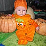 Henry joined the competition — help win amazing prizes! baby, child, pumpkin, orange_clothing, hat, costume, autumn, fall, cute, sitting, blanket, indoor, face, person, festive, holiday, decor, soft_lighting, green_blanket, pumpkin_hat