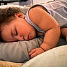 Oko is registered to the contest to win money with this photo: baby, child, sleeping, curly_hair, bed, blanket, pillow, arm, face, peaceful, indoors, soft_lighting, cozy, rest, infant, portrait, toddler, clothing, skin, napping