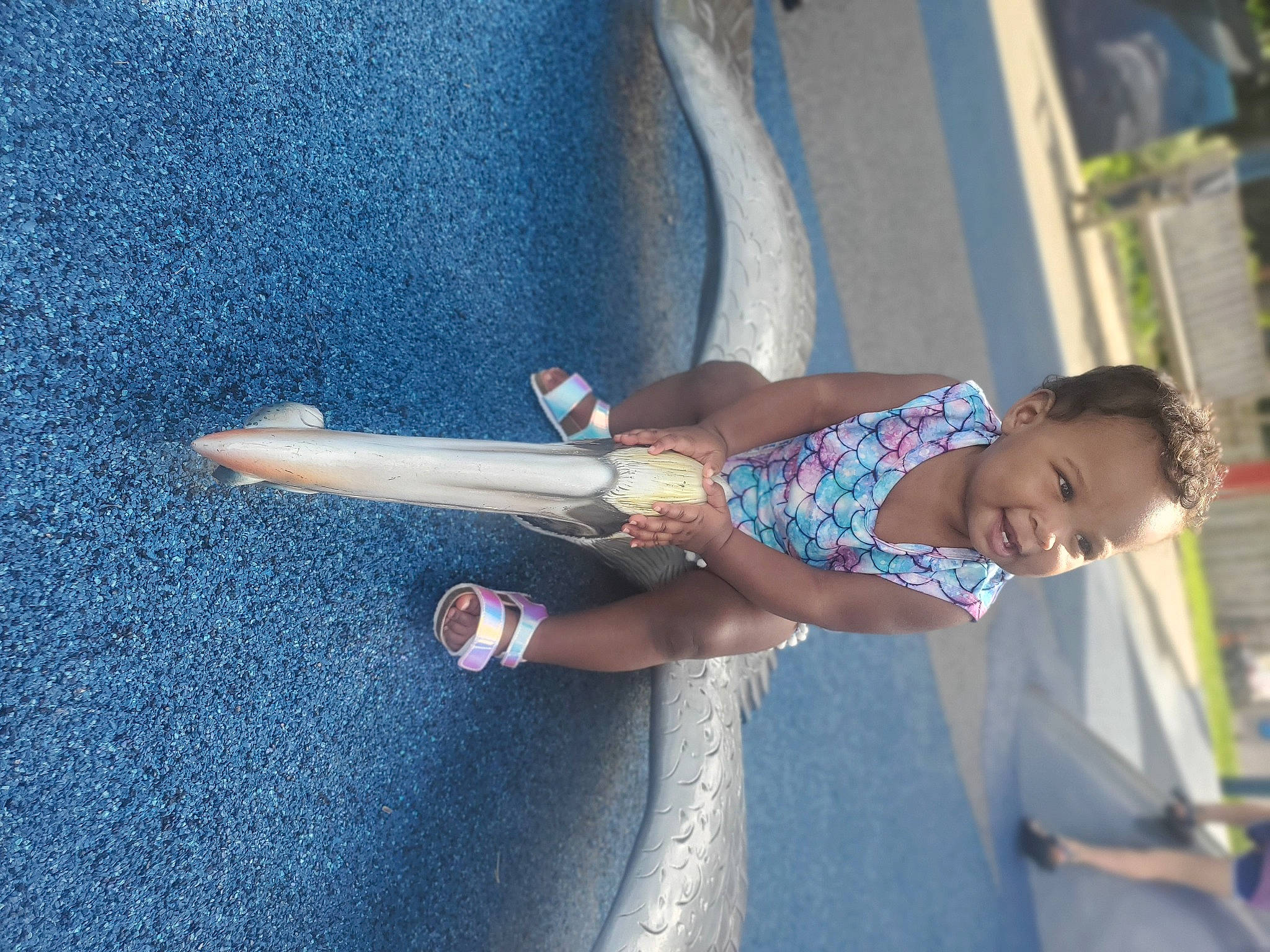 Leona is registered to the contest to win money with this photo: asphalt, azure, blue, elbow, electric_blue, fun, happy, human_leg, joint, knee, leisure, person, road, road_surface, sidewalk, textile, thigh, toddler, tree, vertebrate