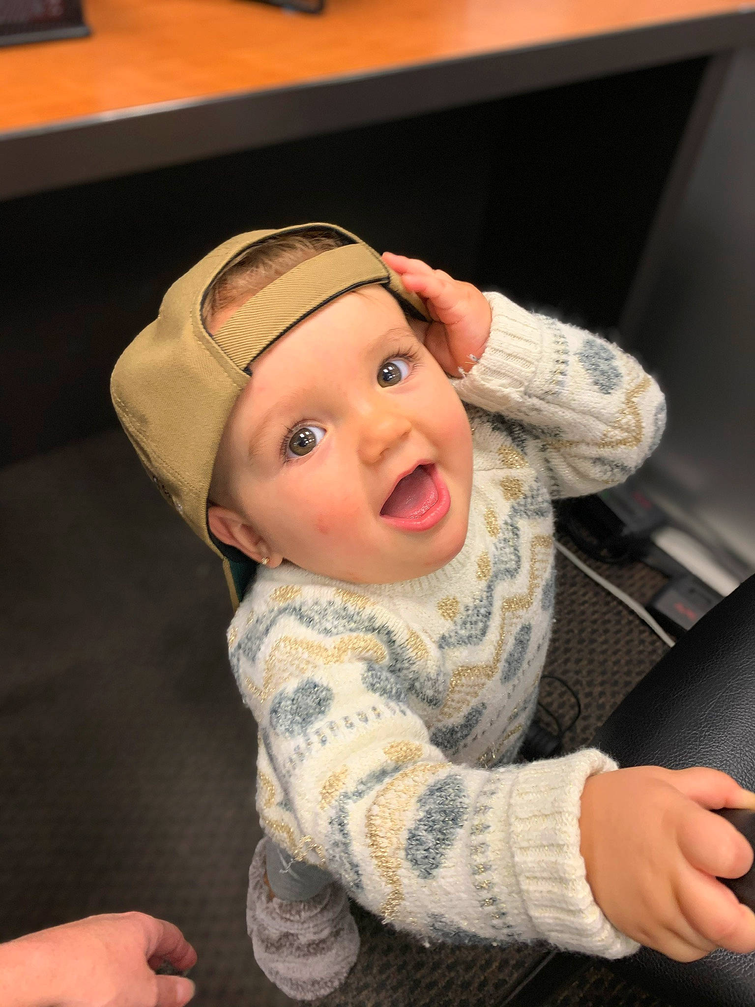 Kylar is registered to the contest to win money with this photo: arm, baby, baseball_cap, beanie, cap, cheek, child, finger, headgear, headwear, person, smile, toddler