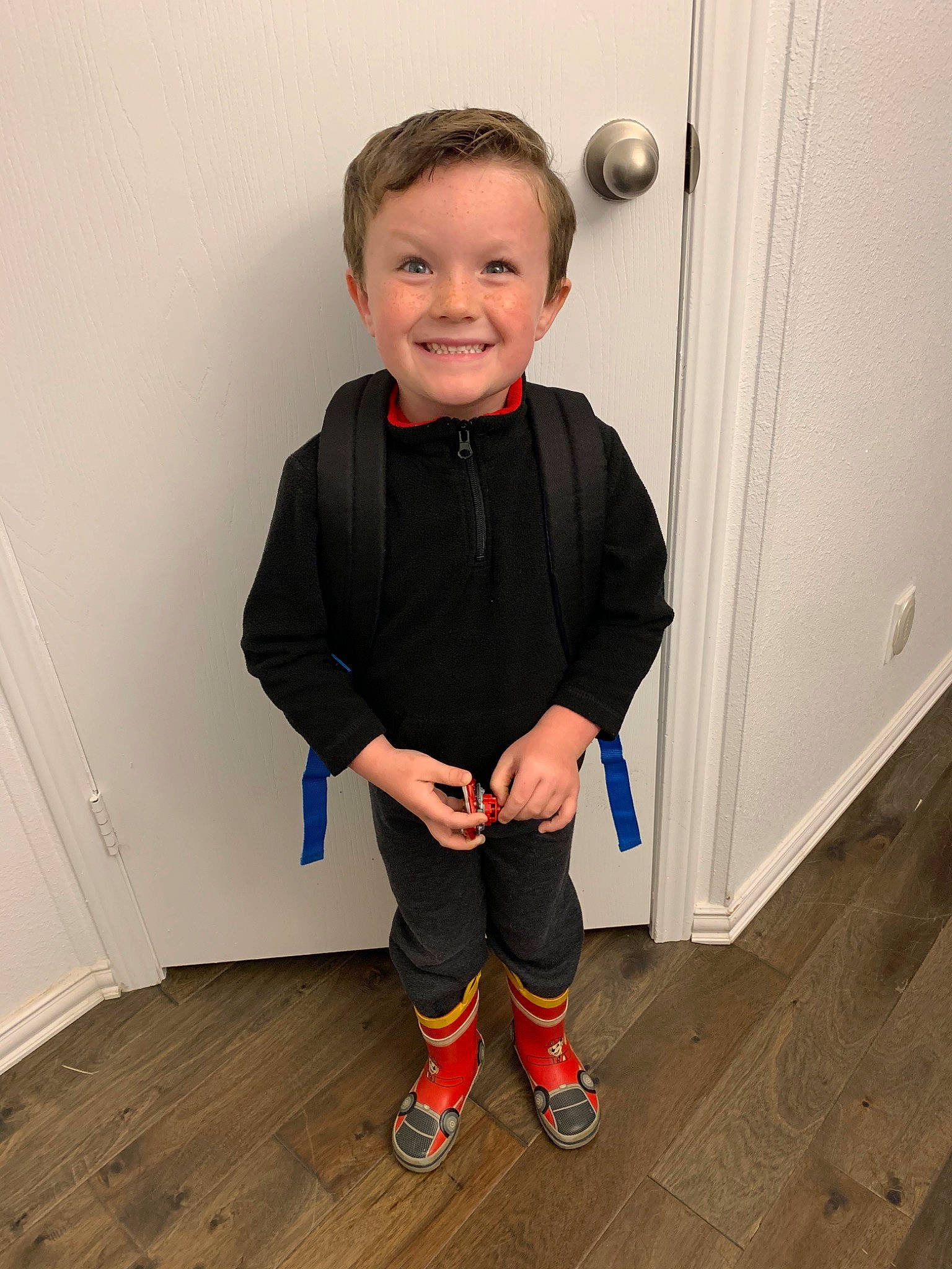 Owen is registered to the contest to win money with this photo: child, costume, floor, flooring, footwear, jacket, joint, joy, leg, outerwear, person, play, shoe, shoulder, sleeve, standing, t_shirt, toddler, trousers