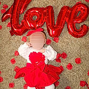 Eleanna a rejoint le concours — aidez-le/la à gagner de superbes lots ! adorable, baby, carpet, celebration, child, colorful, cute, decoration, festive, headband, holiday, indoors, infant, love, lying_down, red_balloons, red_skirt, rose_petals, soft_texture, white_tights