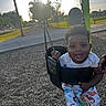 Rakai is registered to the contest to win money with this photo: baby, bench, child, clothing, daytime, dinosaur_pajamas, fun, grass, hand, happy, outside, park, person, play, playground, smiling, sunlight, swing, toddler, tree