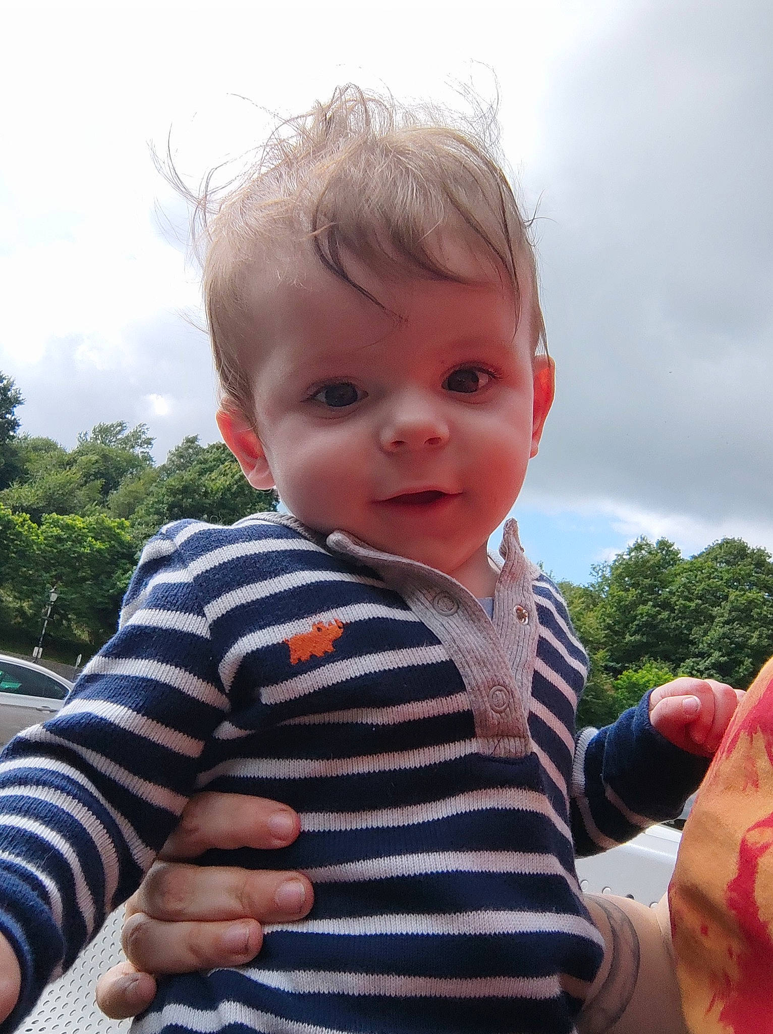 Castiel is registered to the contest to win money with this photo: baby_toddler_clothing, cheek, cloud, cool, eye, finger, gesture, grass, hand, happy, iris, lip, nose, people_in_nature, person, plant, skin, sky, sleeve, toddler