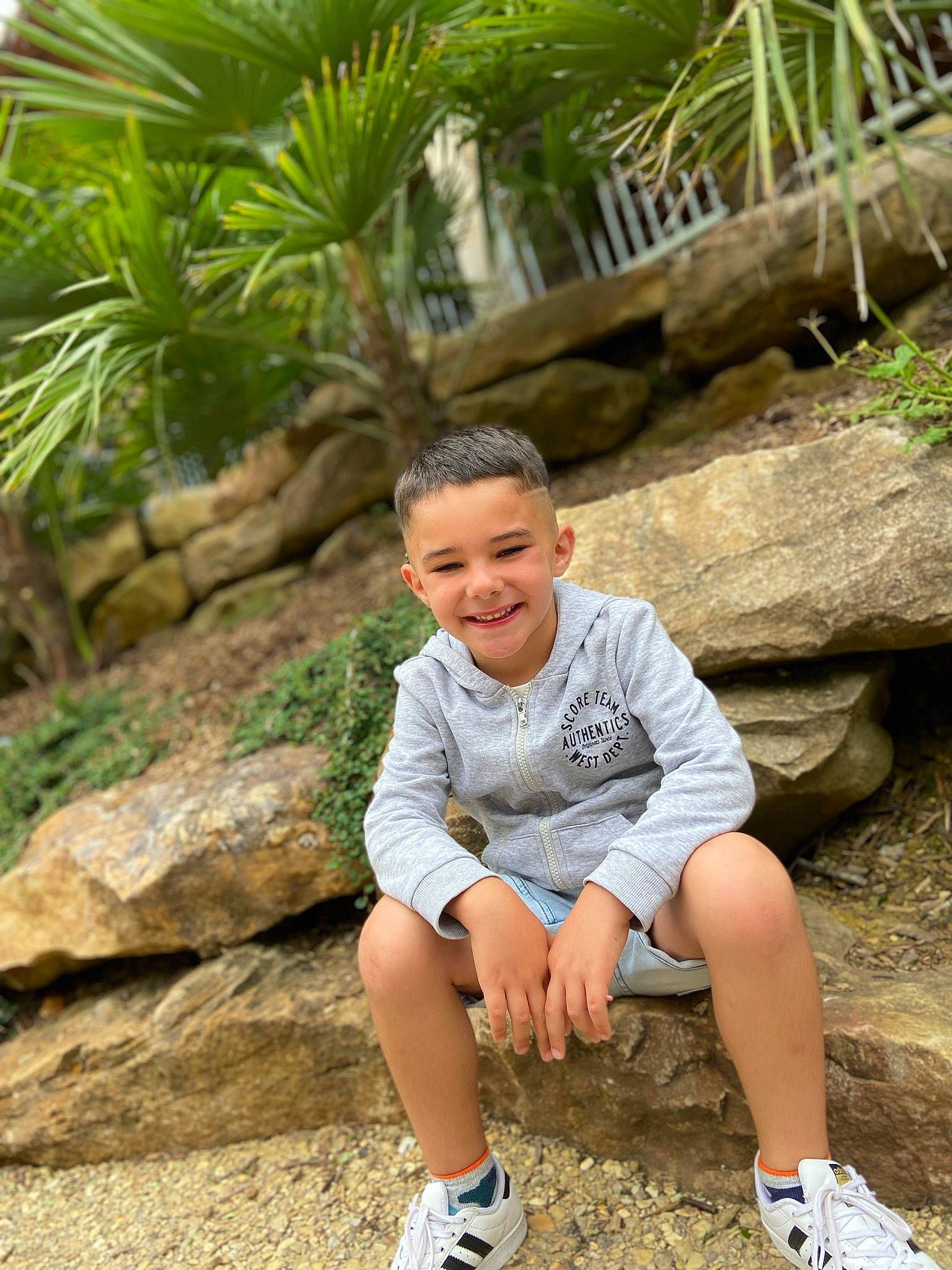 Liséo participe au concours pour gagner de l'argent avec cette photo : arecales, fun, grass, happy, joy, landscape, leisure, mammal, outdoor_shoe, people_in_nature, person, plant, recreation, rock, shorts, smile, soil, t_shirt, toddler, tree