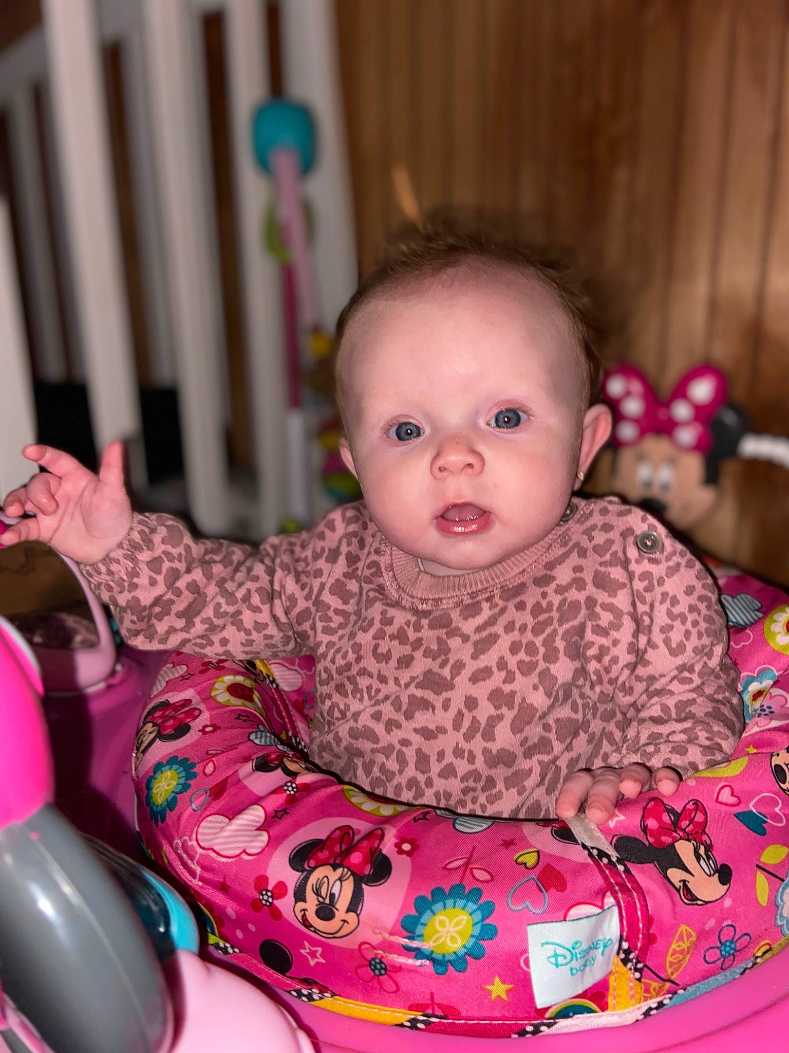 Isabelle is registered to the contest to win money with this photo: baby, baby_products, baby_toddler_clothing, cheek, child, comfort, eye, face, flooring, fun, happy, head, iris, magenta, person, pink, room, sitting, skin, sleeve
