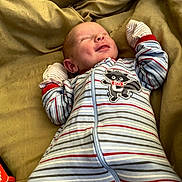 Achilles joined the competition — help win amazing prizes! baby, newborn, smiling, onesie, striped_clothing, raccoon_patch, blanket, bed, sleeping, infant, cute, cozy, soft, child, portrait, resting, happy, small_hands, warm, indoor