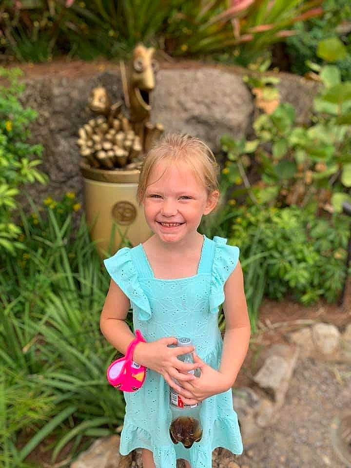 Stormy is registered to the contest to win money with this photo: adaptation, baby_toddler_clothing, botany, eye, flowerpot, grass, grass_family, green, groundcover, hair, happy, joy, landscape, leaf, people_in_nature, person, plant, smile, summer, terrestrial_plant