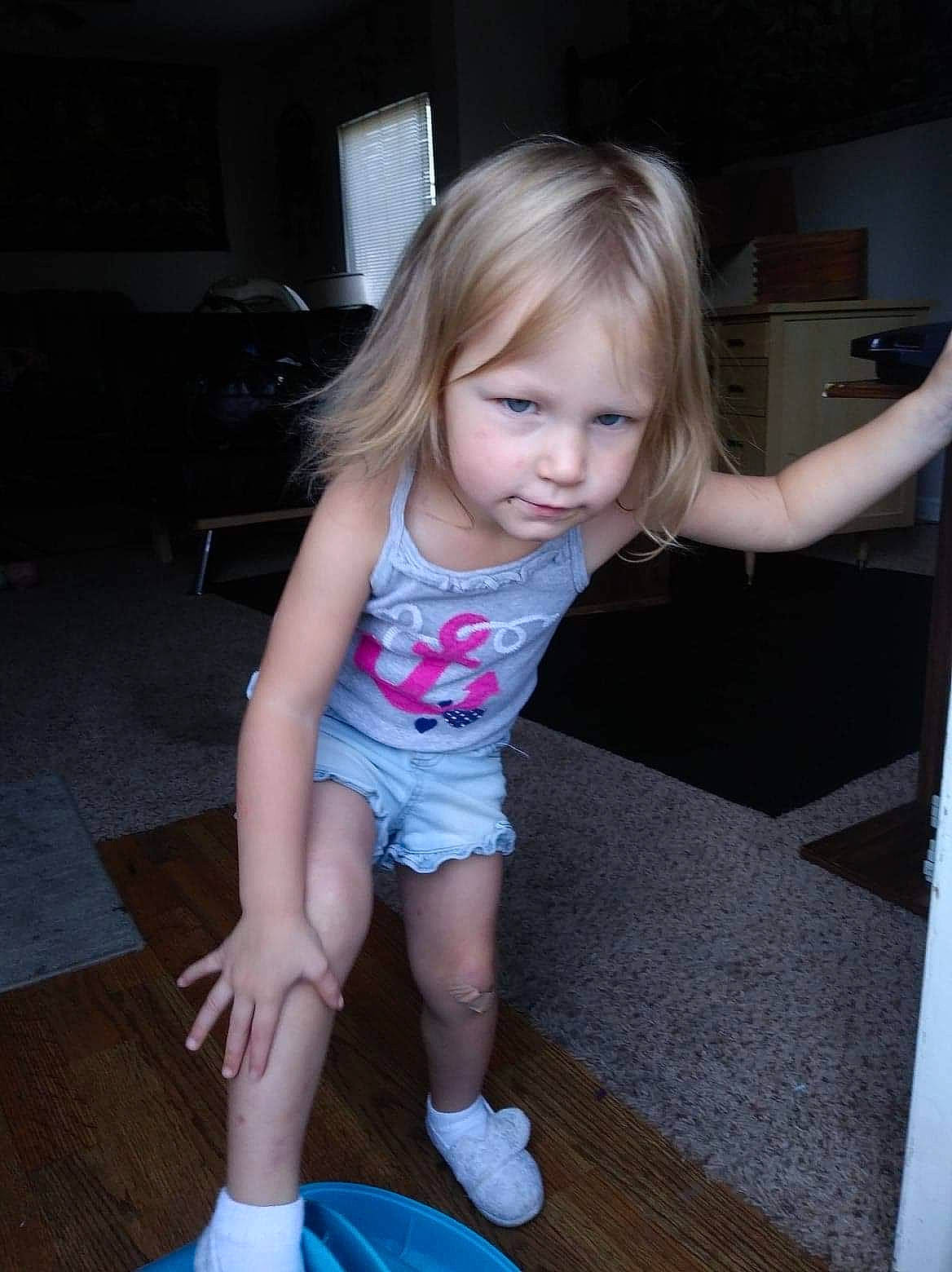 Cathy is registered to the contest to win money with this photo: baby_toddler_clothing, cheek, child, eye, floor, flooring, fun, hair, hardwood, human_leg, iris, joint, knee, person, shorts, shoulder, skin, smile, thigh, toddler