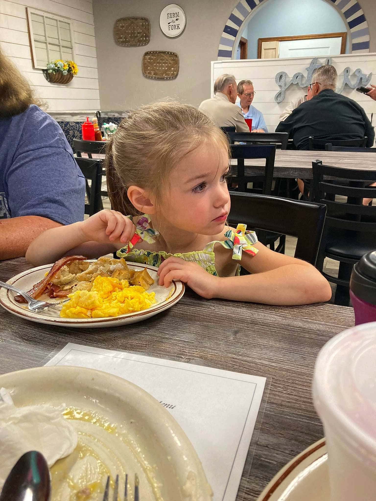 Peyton joined the competition — help win amazing prizes! chair, child, cooking, cuisine, dish, dishware, food, fork, ingredient, kitchen_utensil, person, picture_frame, plate, platter, serveware, sharing, spoon, t_shirt, table, tableware