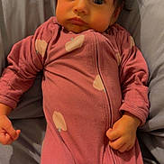 Halo is registered to the contest to win money with this photo: baby, bed, blanket, child, close_up, cozy, expression, gray_bedding, hands, indoors, infant, looking_at_camera, lying_down, onesie, pink_onesie, portrait, soft_lighting, tousled_hair, wide_eyes, zipper