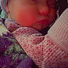 Halo is registered to the contest to win money with this photo: newborn, baby, sleeping, infant, face, portrait, knit_hat, scarf, blanket, bundled, cozy, indoors, close_up, peaceful, resting, swaddled, winter_clothing, soft_lighting, photography, child