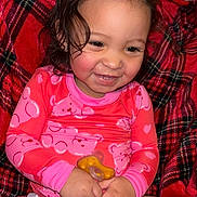 Juniper is registered to the contest to win money with this photo: toddler, child, smiling, baby_bottle, pacifier, pink_clothing, plaid_blanket, indoors, happy, sitting, cute, rosy_cheeks, curly_hair, diaper, person, portrait, young_child, infant, cozy, casual