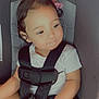Juniper joined the competition — help win amazing prizes! toddler, child, car_seat, safety_harness, pink_bow, curly_hair, white_shirt, seat, baby, cute, young_child, sitting, indoor, portrait, child_seat, straps, small_person, infant, seatbelt, hands