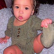 Juniper joined the competition — help win amazing prizes! baby, blanket, bow, brown_eyes, child, childhood, curly_hair, cute, expression, foot, hand, headband, indoor, infant, knitted_clothing, portrait, sitting, skin, sock, warm_clothing