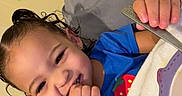 Juniper joined the competition — help win amazing prizes! adult, bed, blanket, blue_shirt, child, cozy, cute, face, hair, hand, happy, indoor, person, pillow, portrait, relaxing, smiling, strawberry, tattoo, toddler