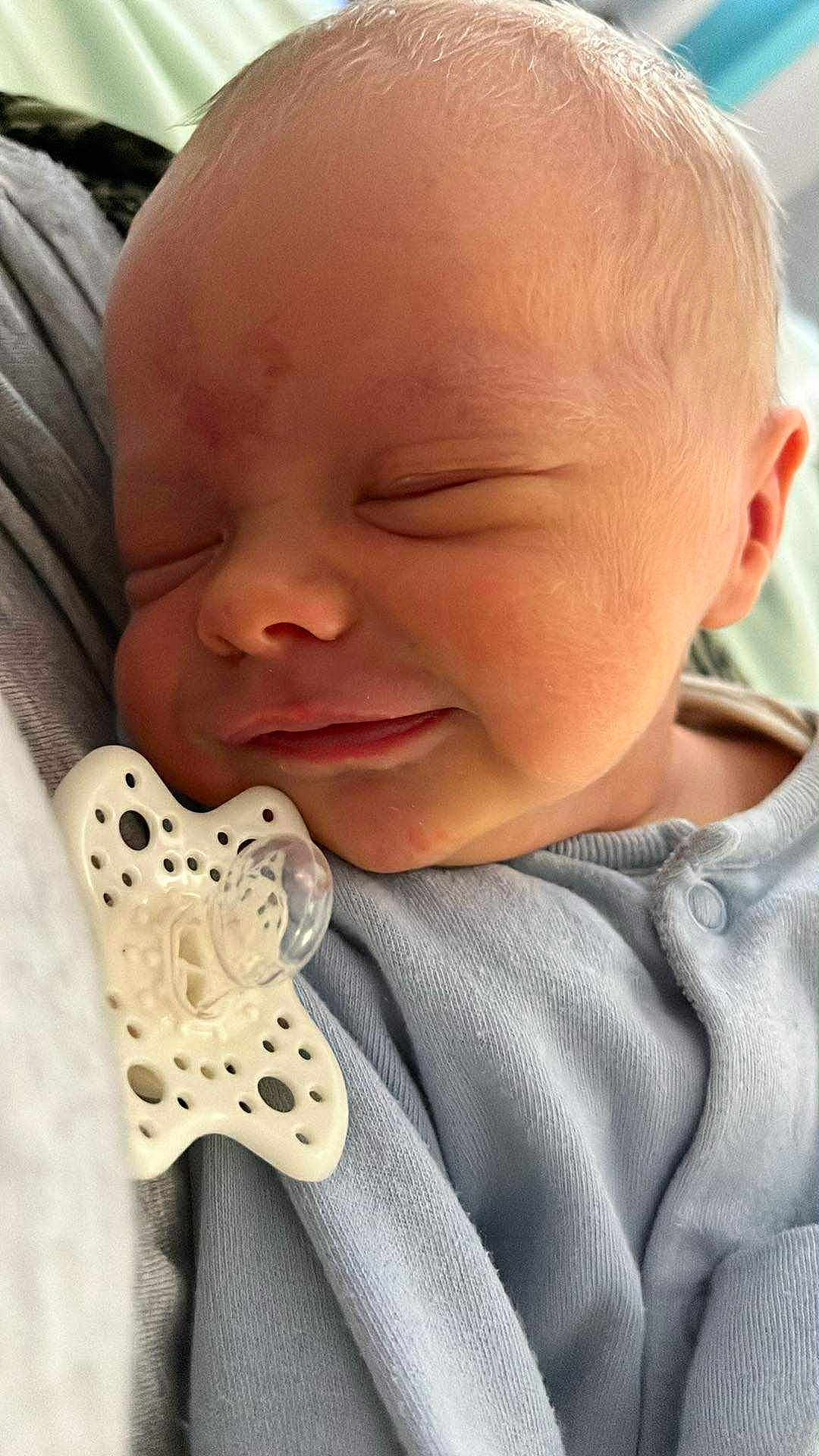 Finley joined the competition — help win amazing prizes! baby, infant, sleeping, pacifier, blue_clothing, close_up, face, skin, newborn, cute, peaceful, resting, child, portrait, soft, indoors, young, small, comfort, cozy