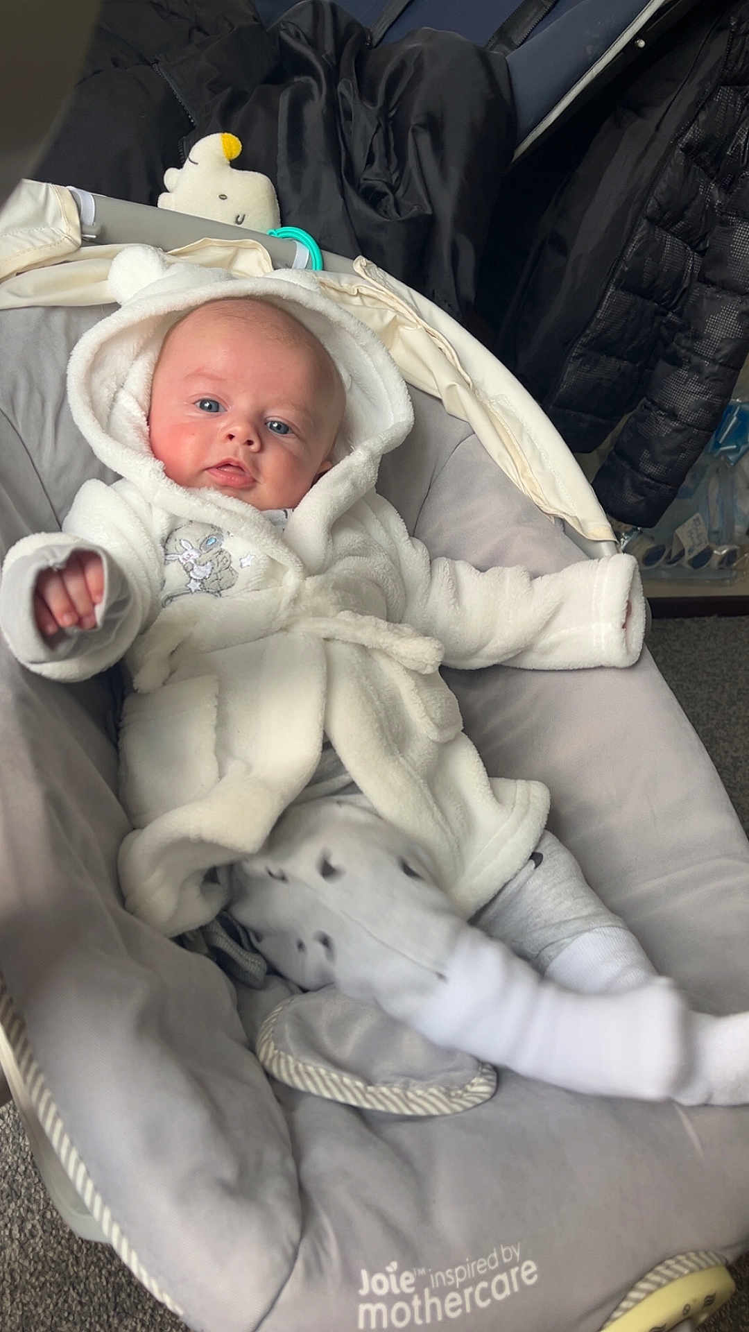 Arlo joined the competition — help win amazing prizes! baby, infant, hoodie, white_clothing, baby_rocker, gray, plush_toy, soft_texture, blue_eyes, indoor, child, cute, cozy, comfort, clothing, person, portrait, baby_clothes, resting, casual
