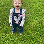 toddler, child, grass, outdoor, barefoot, greenery, cute, playful, clothing, overalls, penguin, long_sleeve_shirt, nature, smile, tongue_out, young_child, happy, casual, daylight, summer