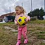 Théa a rejoint le concours — aidez-le/la à gagner de superbes lots ! child, girl, soccer_ball, pink_clothing, sportswear, outdoor, grass, field, cloudy_sky, sports_shoes, soccer_socks, playing, holding, young_child, athletic, fun, daytime, activity, nature, casual