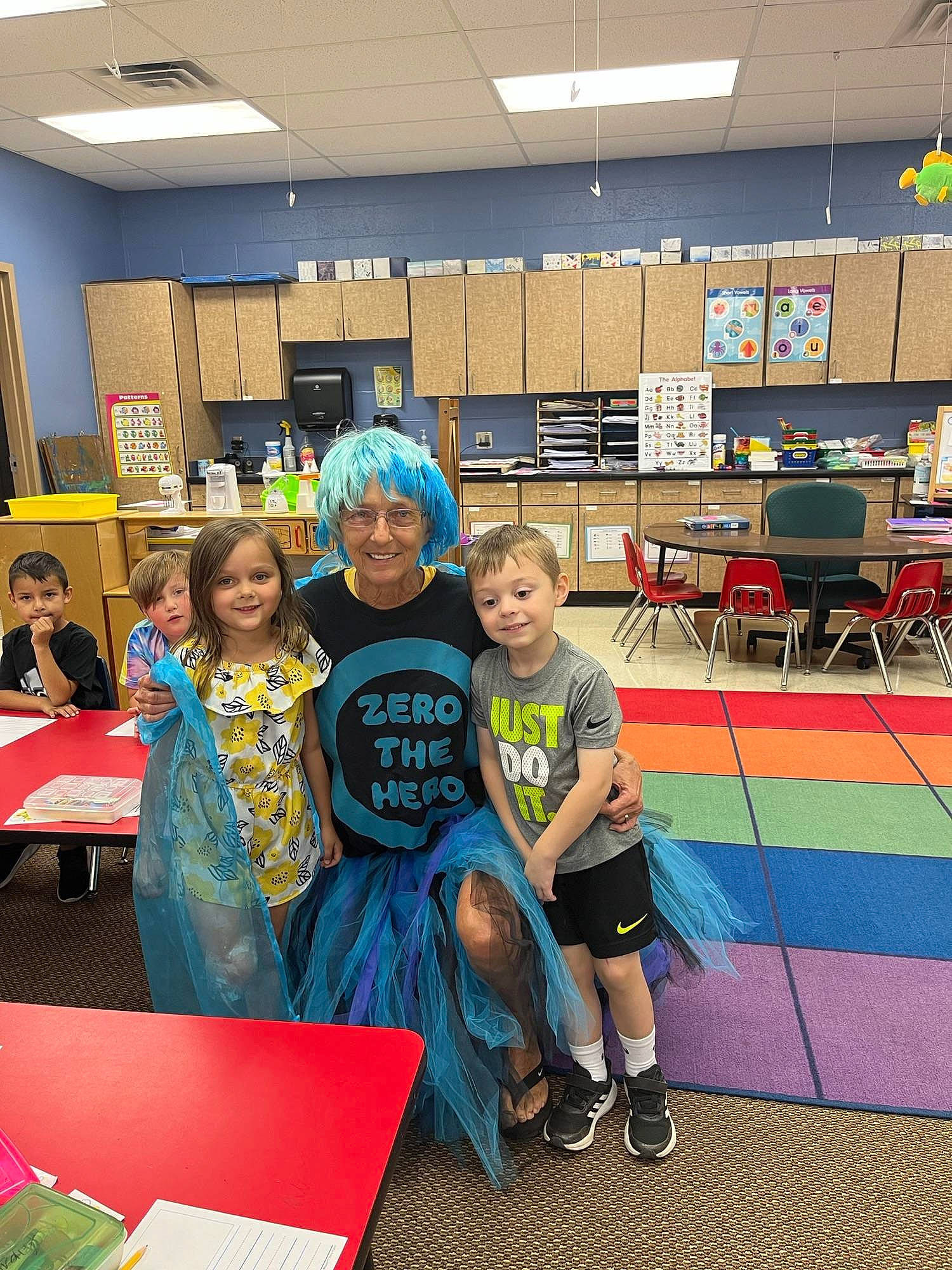 Addisyn joined the competition — help win amazing prizes! academic_institution, chair, child, class, competition_event, desk, event, flooring, fun, games, joy, kindergarten, leisure, person, recreation, room, school, smile, t_shirt, table