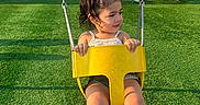 Kiki joined the competition — help win amazing prizes! child, swing, playground, yellow, grass, park, outdoor, play_equipment, trees, people, daylight, fun, casual_clothing, shoes, person, summer, activity, smile, hair, recreation