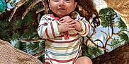 Brewer is registered to the contest to win money with this photo: baby, infant, smiling, striped_onesie, blanket, nature_print, feet, socks, clothing, floor, wood_floor, happy, lying_down, child, person, indoor, cute, portrait, baby_toy, pacifier
