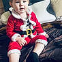 Tayler a rejoint le concours — aidez-le/la à gagner de superbes lots ! toddler, child, santa_outfit, red_clothing, black_socks, bed, pillow, blanket, indoor, portrait, cute, holiday, christmas, smile, face, person, young_child, sitting, cozy, head