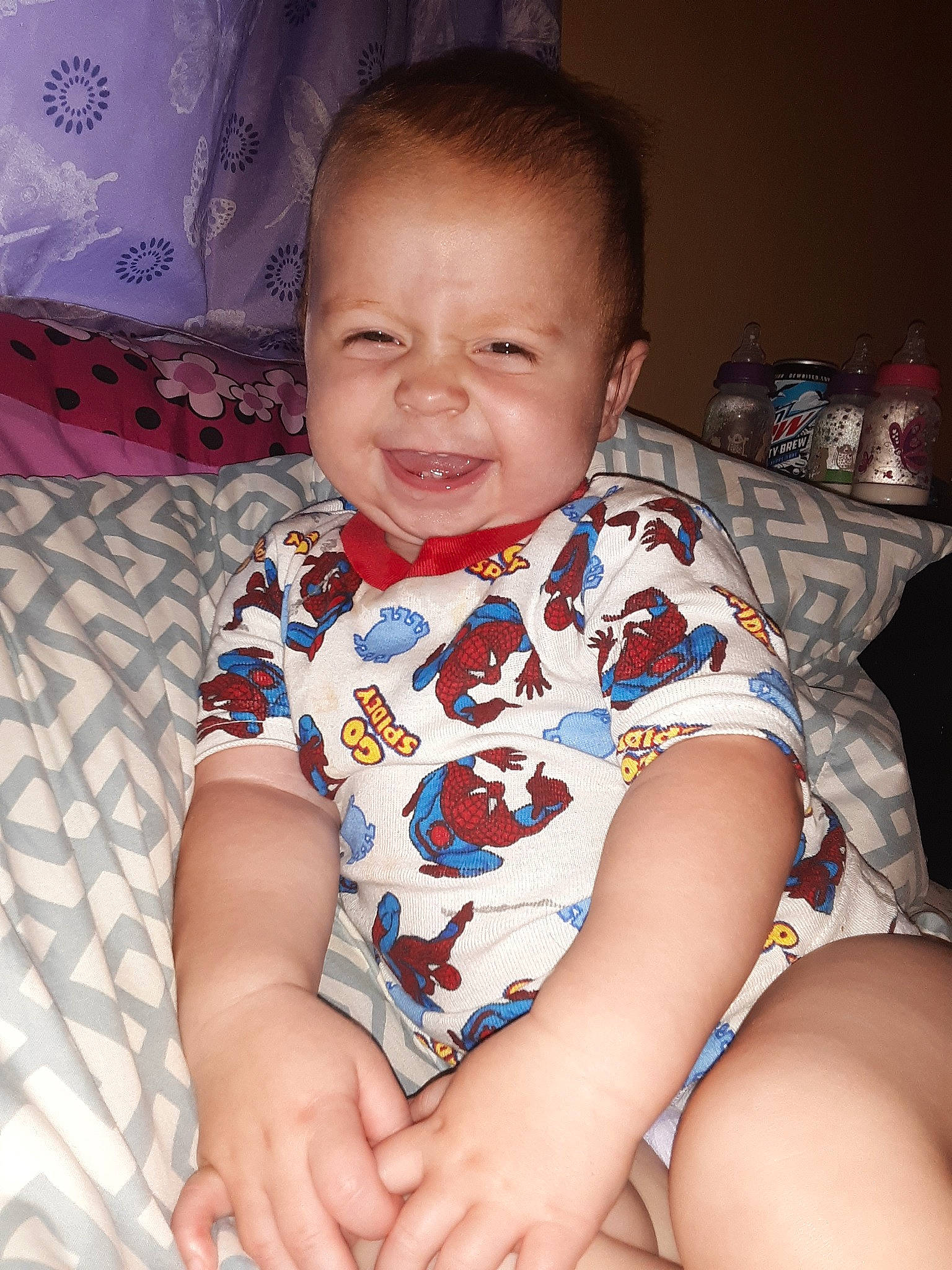 Maverick is registered to the contest to win money with this photo: arm, baby, baby_toddler_clothing, cheek, child, chin, eye, face, facial_expression, finger, fun, head, iris, joy, leg, mouth, nose, person, sitting, skin