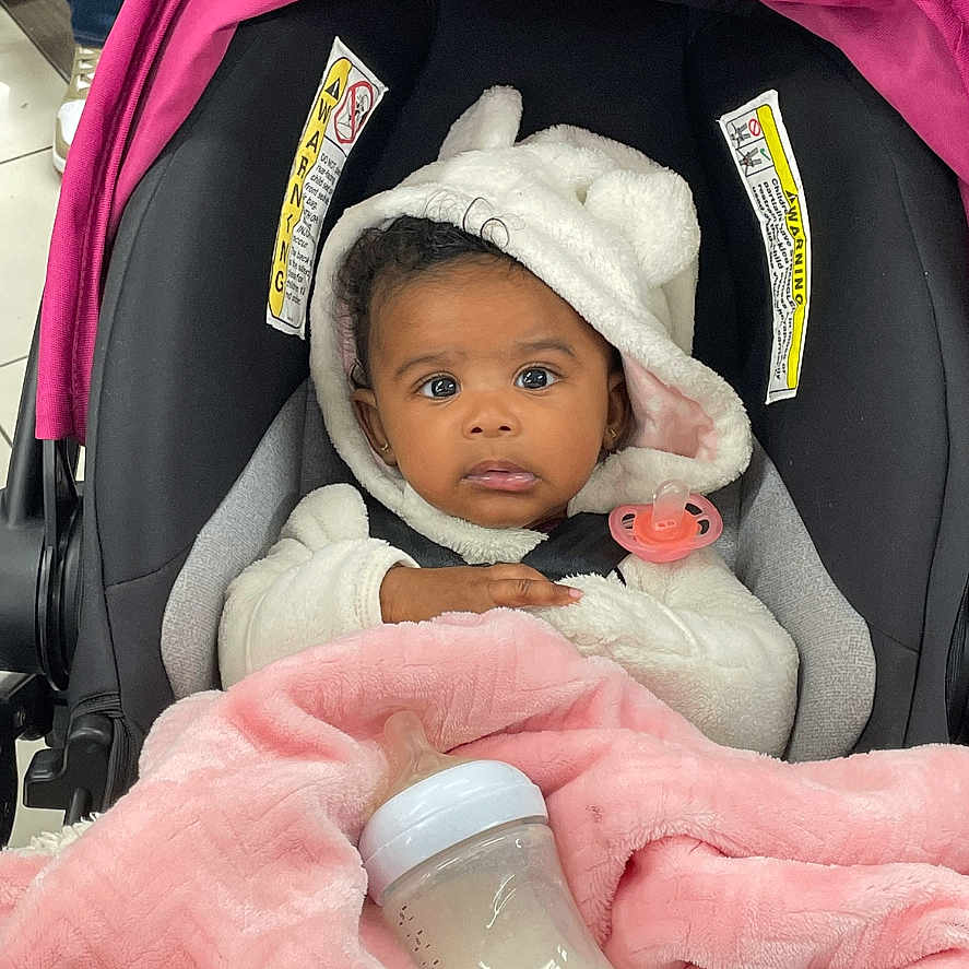 Kamoura-Armani joined the competition — help win amazing prizes! adult, baby, beverage, bonnet, cap, clothing, crib, face, female, footwear, furniture, hat, head, infantbed, milk, person, photography, portrait, shoe, woman