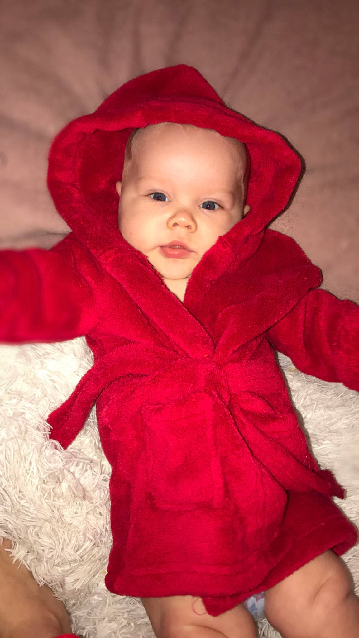 Cohan is registered to the contest to win money with this photo: baby, child, clothing, fur, hood, hoodie, outerwear, person, red, skin, sleeve, toddler