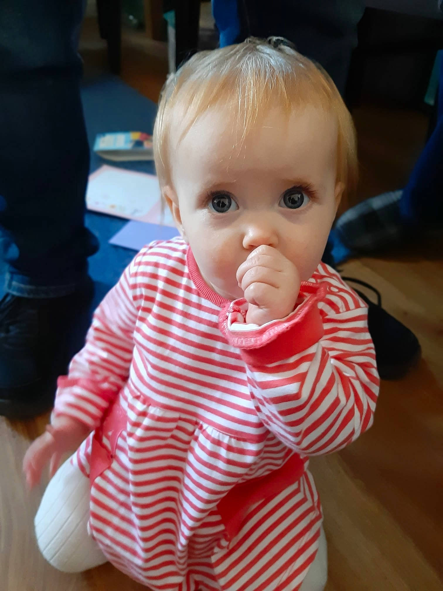 Maisie is registered to the contest to win money with this photo: baby, baby_toddler_clothing, cheek, child, chin, collar, eye, eyelash, finger, flooring, fun, iris, lip, nose, pattern, person, sitting, skin, sleeve, thumb