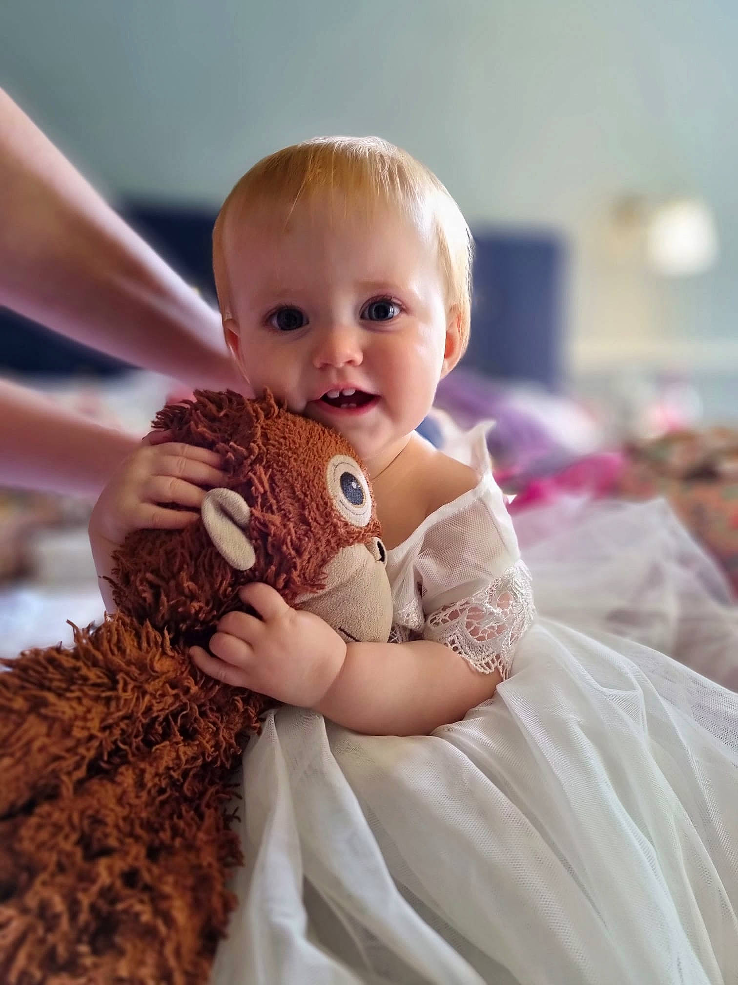 Maisie is registered to the contest to win money with this photo: arm, baby, baby_toddler_clothing, blond, child, doll, dress, event, fashion_design, finger, fur, gesture, hand, happy, person, shoulder, skin, stuffed_toy, teddy_bear, toddler
