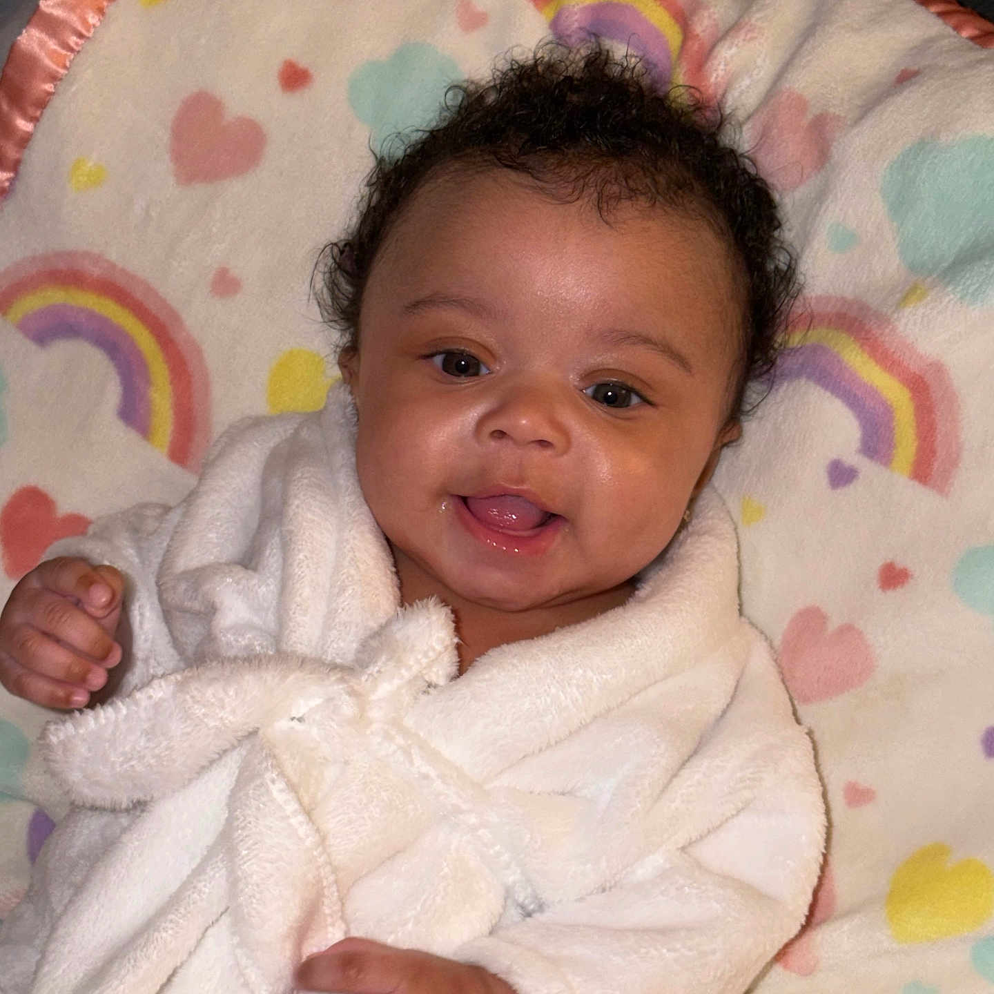 Kali Eve joined the competition — help win amazing prizes! baby, infant, smiling, robe, blanket, rainbow, hearts, cute, happy, child, soft, cozy, portrait, indoor, closeup, face, expression, skin, person, newborn