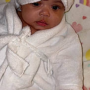 Kali Eve is registered to the contest to win money with this photo: baby, child, face, robe, towel, wrapped, cute, indoors, portrait, soft, colorful_background, heart_pattern, rainbow_pattern, skin, expression, looking, newborn, infant, clothing, sleepwear