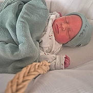 Paul a rejoint le concours — aidez-le/la à gagner de superbes lots ! newborn, baby, sleeping, blanket, cap, soft, wrapped, peaceful, infant, cute, cozy, white_background, resting, small_hand, face, headwear, indoors, closeup, quiet, child