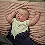 Waylon is registered to the contest to win money with this photo: baby, sleeping, pillow, infant, arms_up, cozy, blanket, soft_texture, peaceful, face, clothing, cute, resting, indoors, child, toddler, pink, comfort, portrait, young
