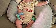 Waylon is registered to the contest to win money with this photo: baby, sleeping, cushion, pillow, toy, overalls, car_print, mittens, infant, indoor, carpet, child, cute, soft, comfort, relaxing, seated, clothing, fabric, nap