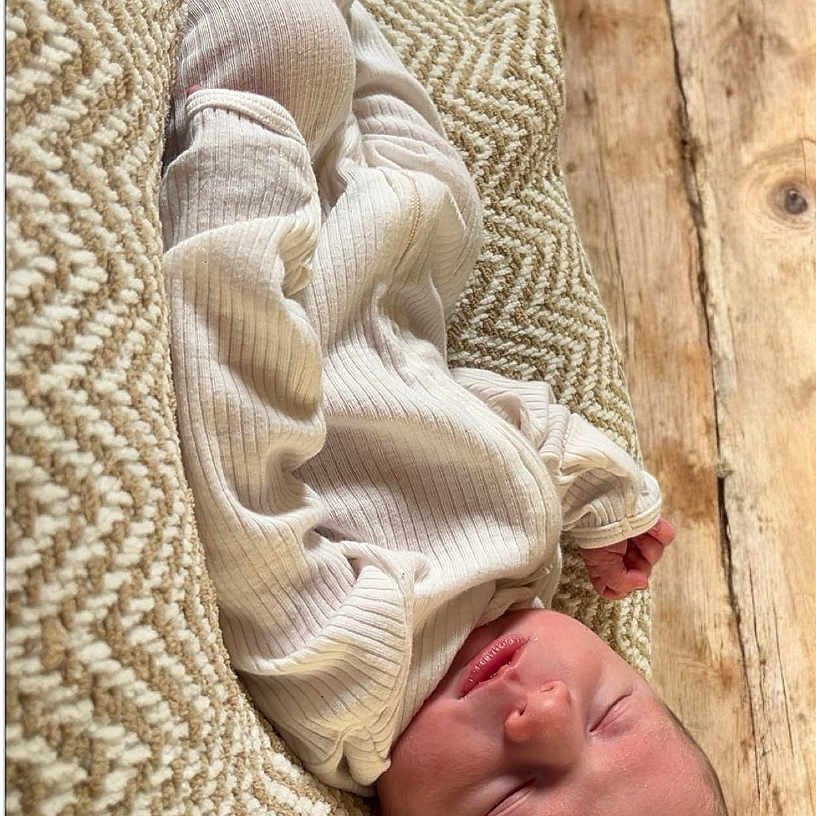 Waylon joined the competition — help win amazing prizes! baby, blanket, child, closeup, cozy, cute, indoors, infant, natural_light, newborn, peaceful, portrait, relaxation, resting, ribbed_clothing, sleeping, soft_texture, tiny_hands, warm_colors, wooden_floor