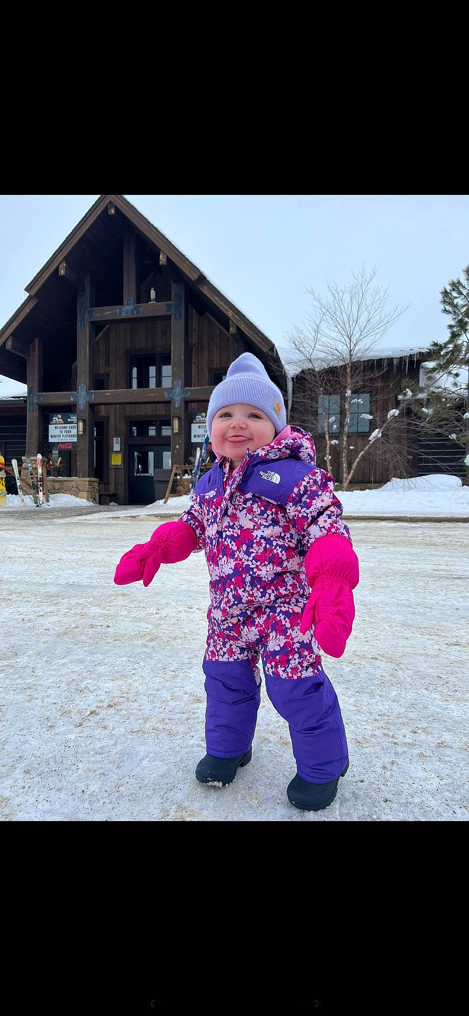 Ellie is registered to the contest to win money with this photo: baby_toddler_clothing, building, child, electric_blue, freezing, fun, happy, headwear, jacket, joy, leisure, magenta, person, pink, purple, recreation, sky, sleeve, smile, snow