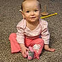 child, toddler, baby, sitting, carpet, toy, pink_clothing, hello_kitty, sock, smile, blue_eyes, indoor, playroom, ball_pit, nursery, candid, portrait, cute, floor, playful