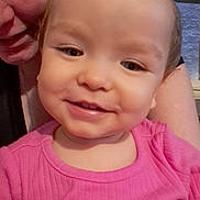 Elaina is registered to the contest to win money with this photo: baby, infant, child, smile, woman, adult, selfie, portrait, indoor, pink_dress, clothing, cheeks, eyes, face, close_up, holding, hair, window, happy, family